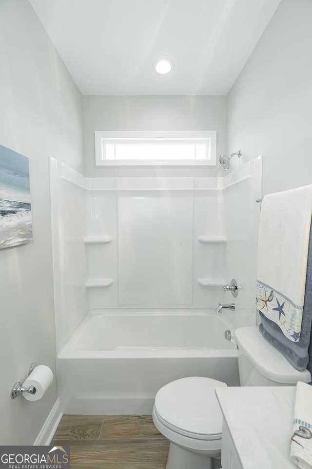 full bathroom featuring wood-type flooring,  shower combination, and plenty of natural light