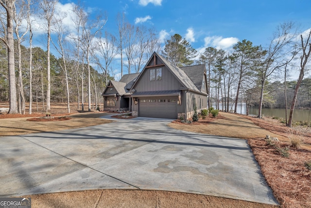 view of front of home with a water view and a garage