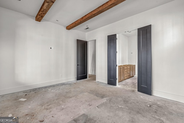 unfurnished bedroom featuring beam ceiling