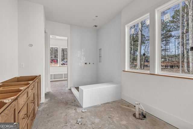 bathroom with concrete floors and a wealth of natural light