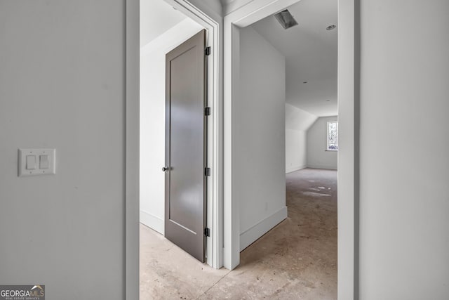 hall featuring vaulted ceiling