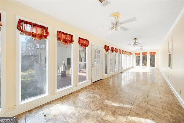 unfurnished sunroom with ceiling fan