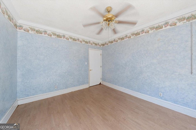 spare room with hardwood / wood-style floors, ceiling fan, crown molding, and a textured ceiling