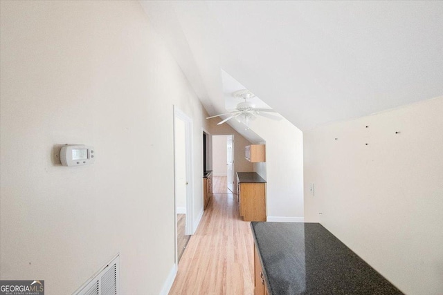 additional living space with hardwood / wood-style floors and lofted ceiling