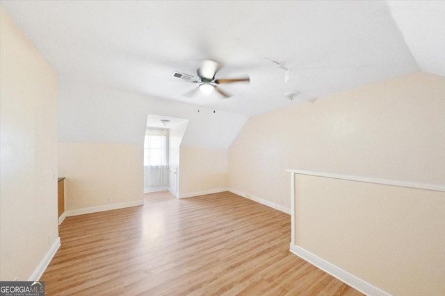 additional living space with ceiling fan, lofted ceiling, and light wood-type flooring