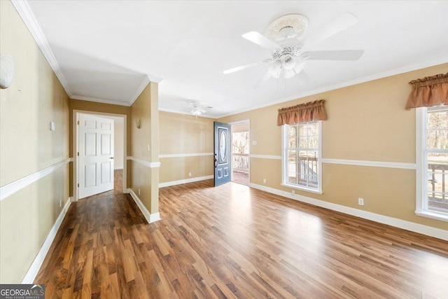 empty room featuring hardwood / wood-style floors, ceiling fan, and ornamental molding