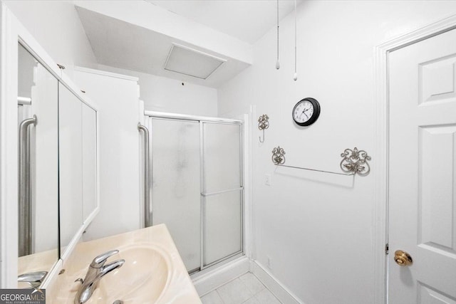 bathroom with tile patterned flooring, vanity, and walk in shower