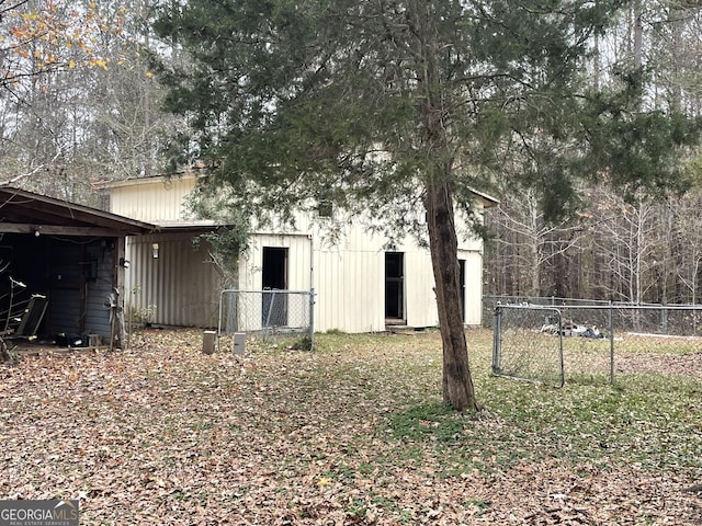 rear view of property with an outdoor structure