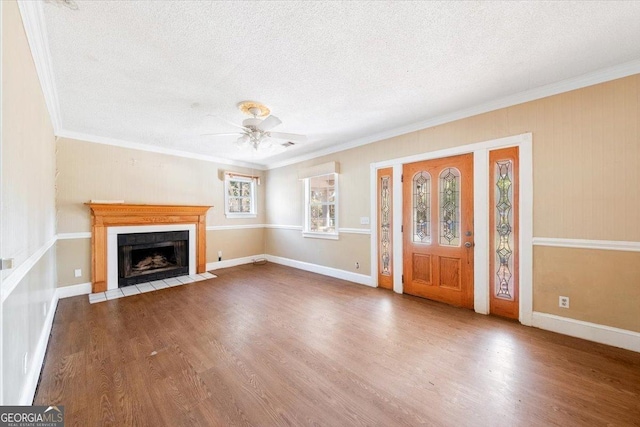 unfurnished living room with hardwood / wood-style floors, a textured ceiling, ceiling fan, and crown molding