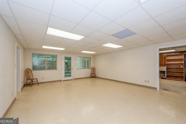 unfurnished room with a drop ceiling