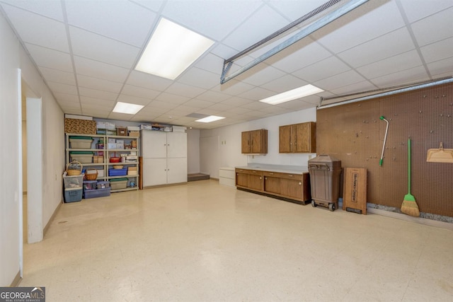 basement with a paneled ceiling