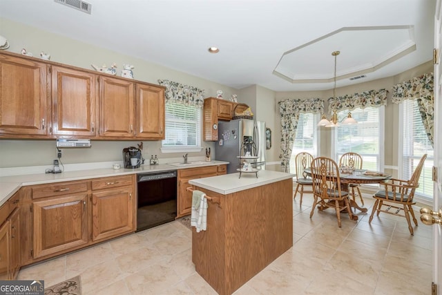 kitchen with pendant lighting, dishwasher, a tray ceiling, a kitchen island, and stainless steel refrigerator