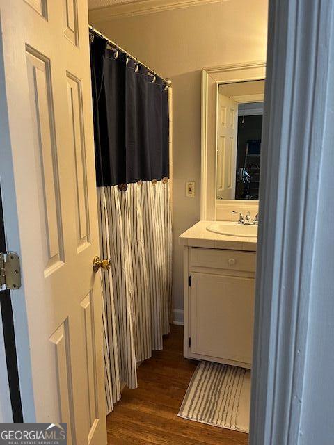 bathroom featuring hardwood / wood-style flooring and vanity