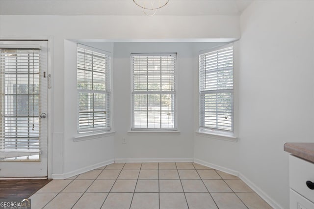 unfurnished dining area featuring light tile patterned flooring