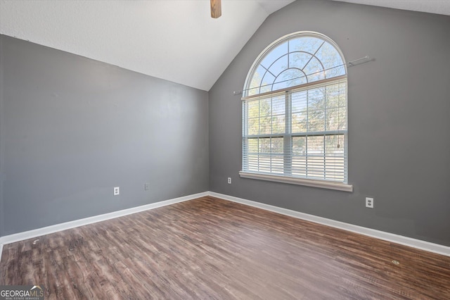 unfurnished room with lofted ceiling, wood-type flooring, ceiling fan, and plenty of natural light