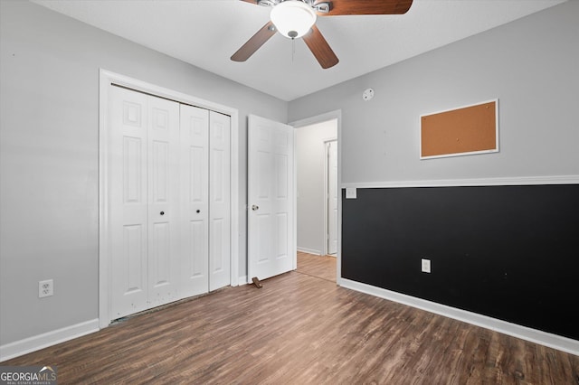 unfurnished bedroom featuring a closet, ceiling fan, and dark hardwood / wood-style floors