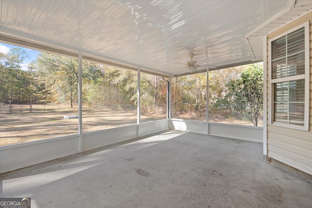 unfurnished sunroom featuring ceiling fan