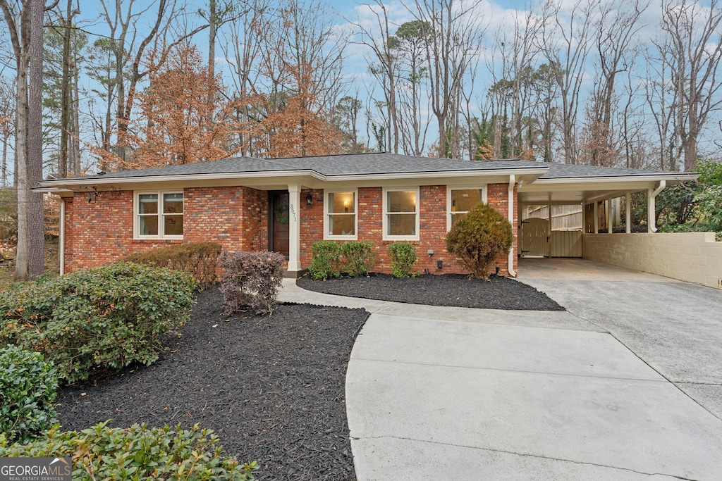 ranch-style home featuring a carport