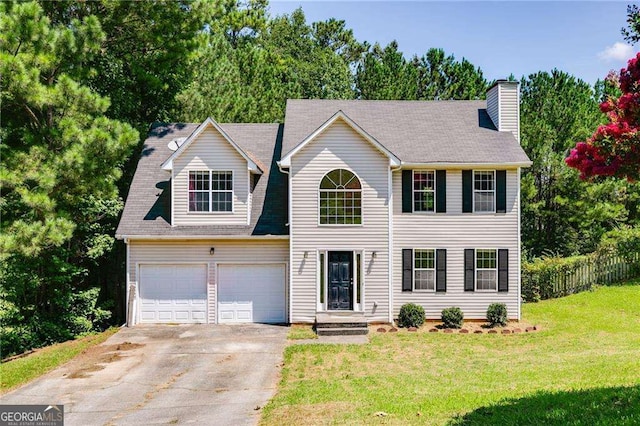 view of front of house with a front lawn and a garage