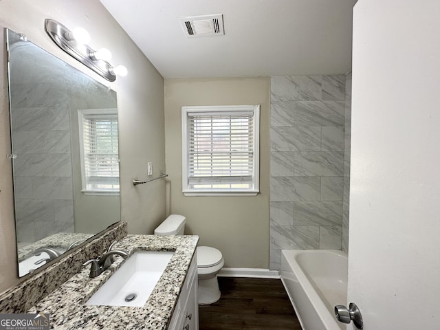 bathroom with hardwood / wood-style flooring, vanity, and toilet