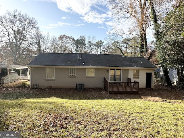 rear view of house featuring a lawn, central AC, and a wooden deck