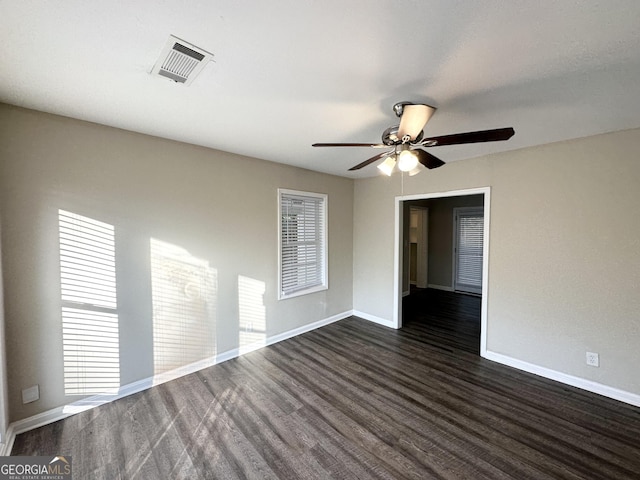 spare room with ceiling fan and dark hardwood / wood-style flooring