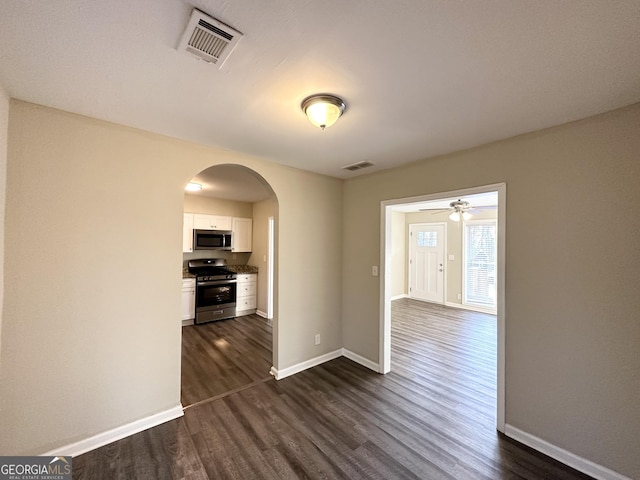 interior space with dark hardwood / wood-style flooring and ceiling fan