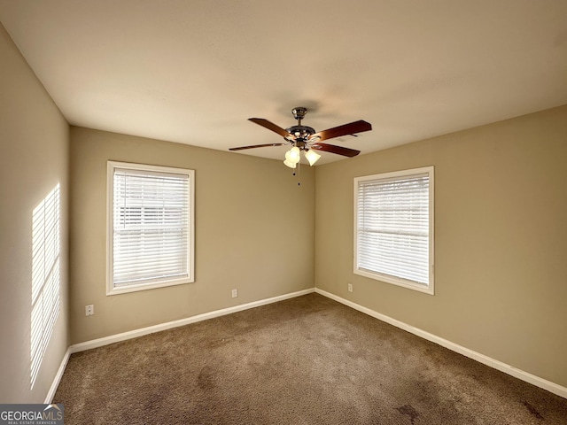 carpeted empty room featuring plenty of natural light and ceiling fan