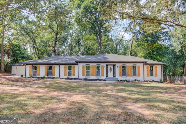 ranch-style house with a front yard and a garage