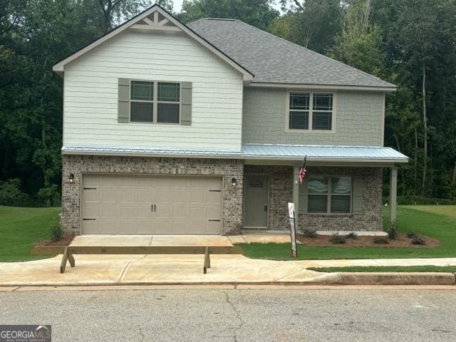 view of front facade with a garage and a front yard