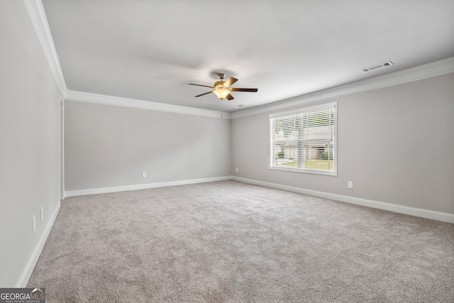 carpeted spare room featuring ornamental molding and ceiling fan