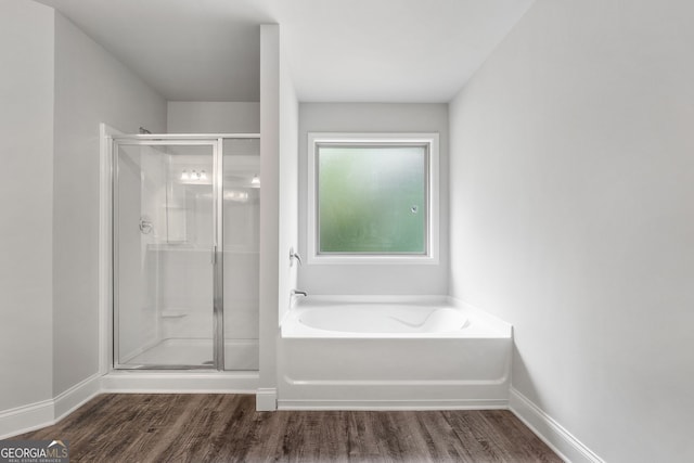 bathroom with hardwood / wood-style floors and plus walk in shower