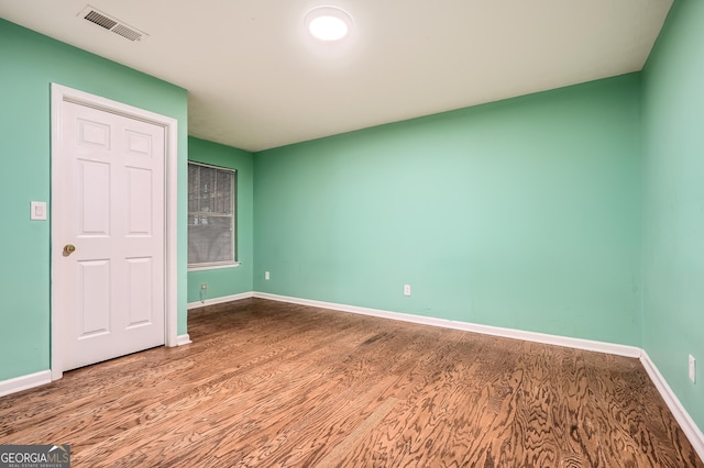 spare room with wood-type flooring