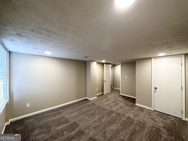 basement with carpet and a textured ceiling