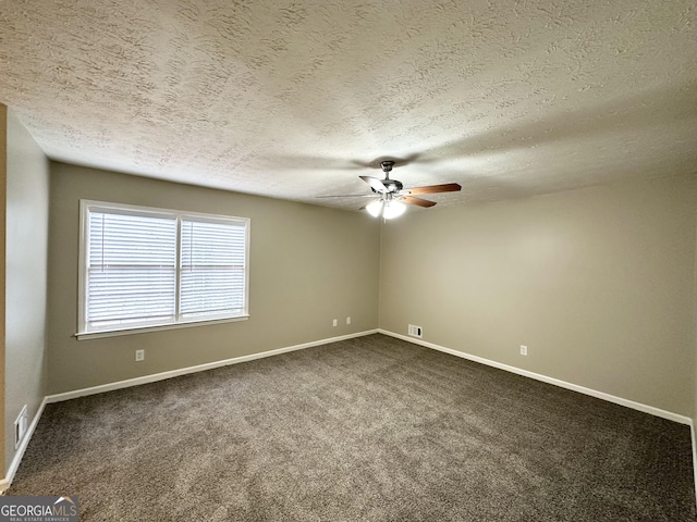 carpeted spare room featuring ceiling fan and a textured ceiling