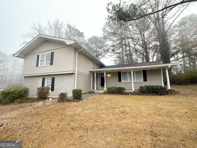 split level home featuring a front lawn