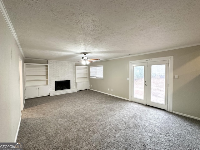 unfurnished living room with dark colored carpet, a textured ceiling, plenty of natural light, and crown molding