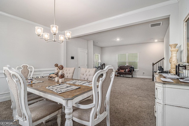 carpeted dining area with a notable chandelier and ornamental molding