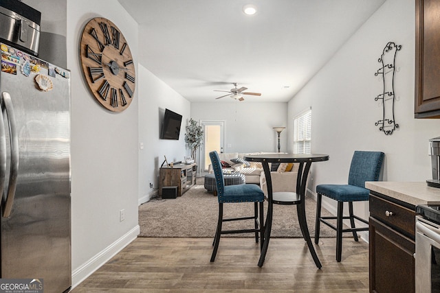 dining area featuring ceiling fan and light hardwood / wood-style floors