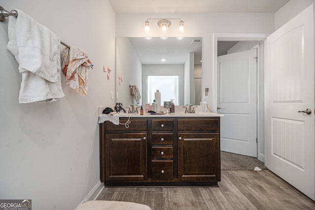 bathroom featuring hardwood / wood-style floors and vanity