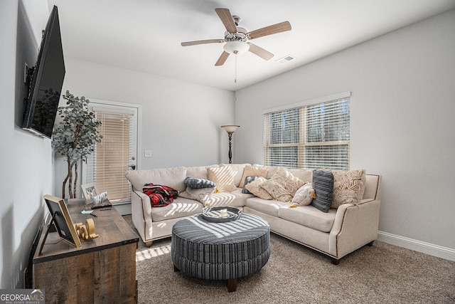 carpeted living room featuring ceiling fan