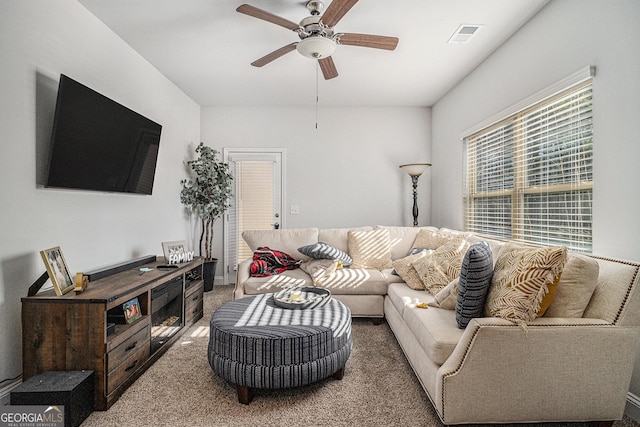 living room with ceiling fan and carpet floors