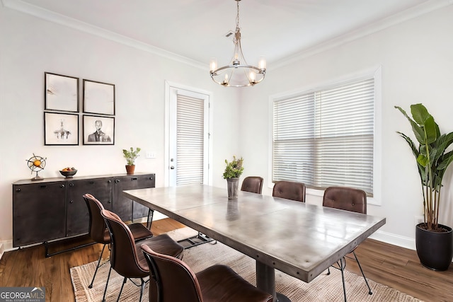dining room with a chandelier, crown molding, and dark wood-type flooring