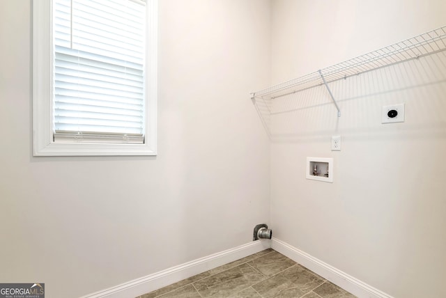 clothes washing area featuring hookup for an electric dryer, hookup for a washing machine, and tile patterned floors
