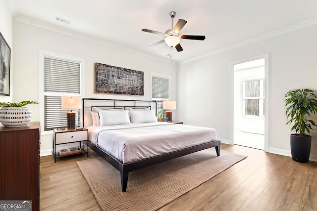 bedroom featuring ceiling fan, light hardwood / wood-style flooring, and ornamental molding