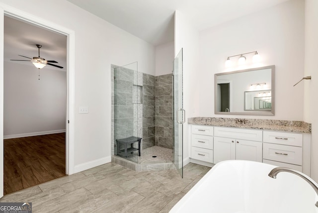 bathroom featuring separate shower and tub, ceiling fan, and vanity