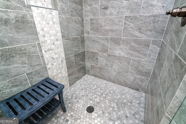 bathroom with tiled shower