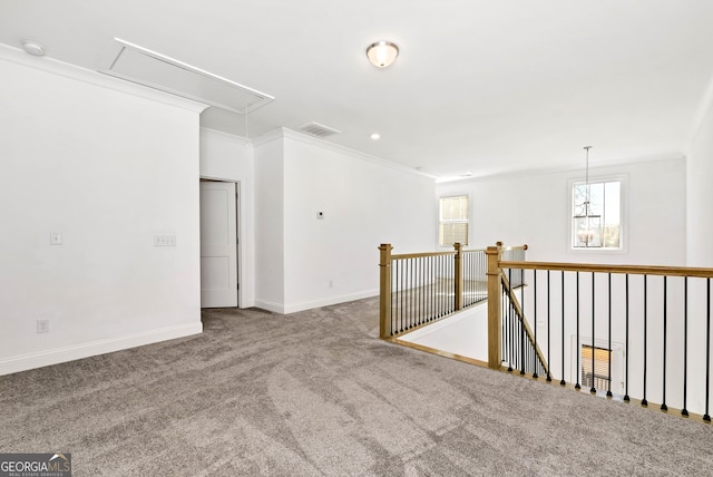 empty room featuring carpet flooring and crown molding