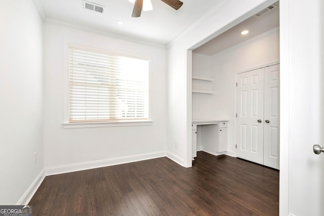 interior space with dark hardwood / wood-style flooring, ceiling fan, and ornamental molding
