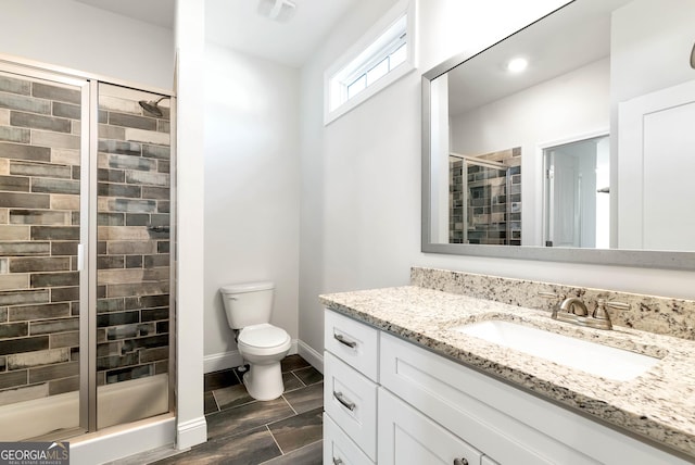 bathroom featuring vanity, toilet, and walk in shower